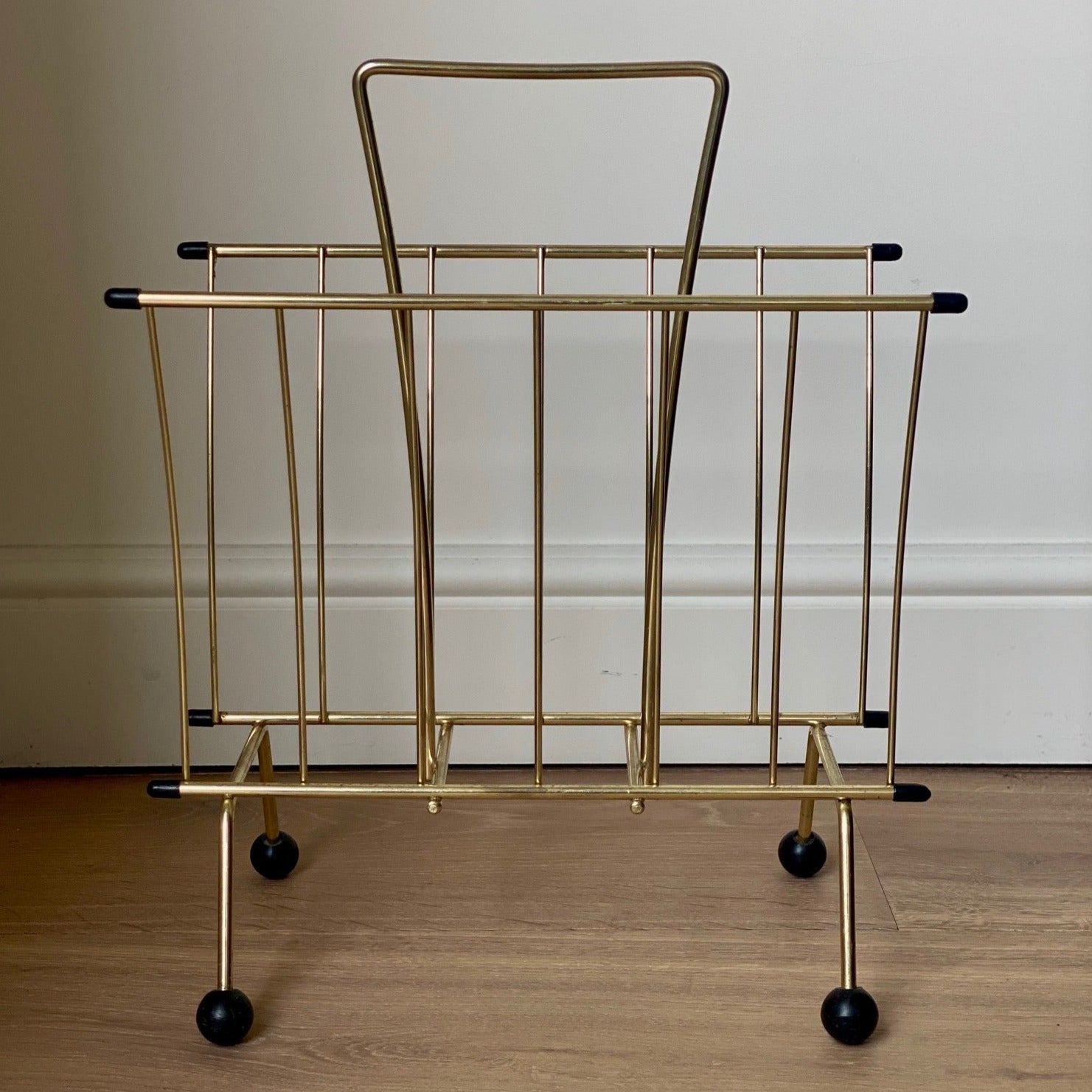 Brass magazine rack with ball feet