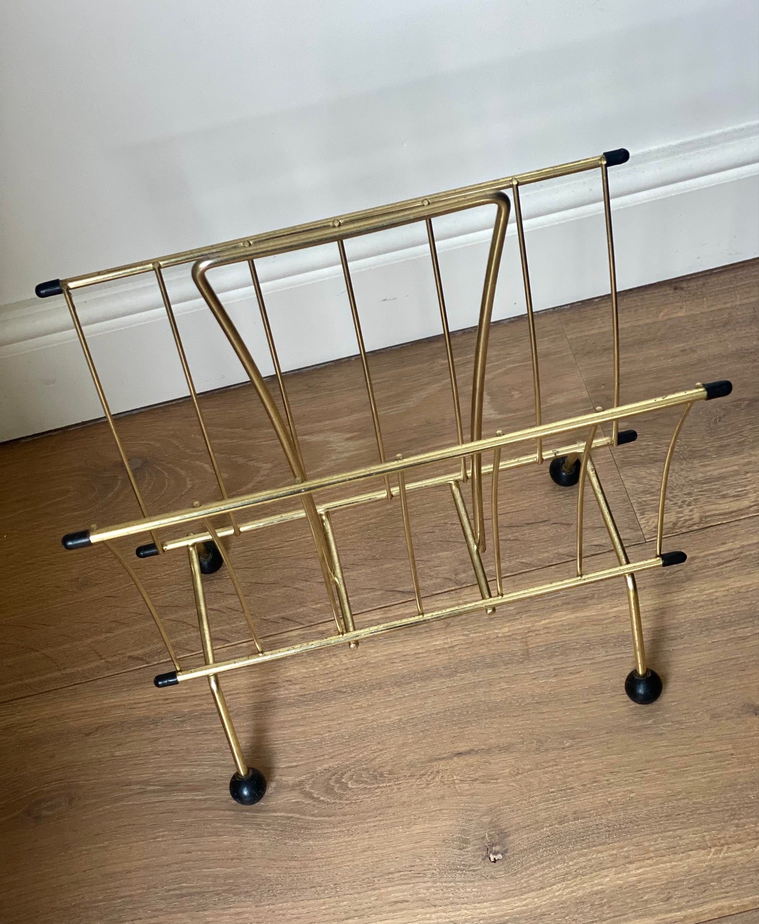 Brass magazine rack with ball feet