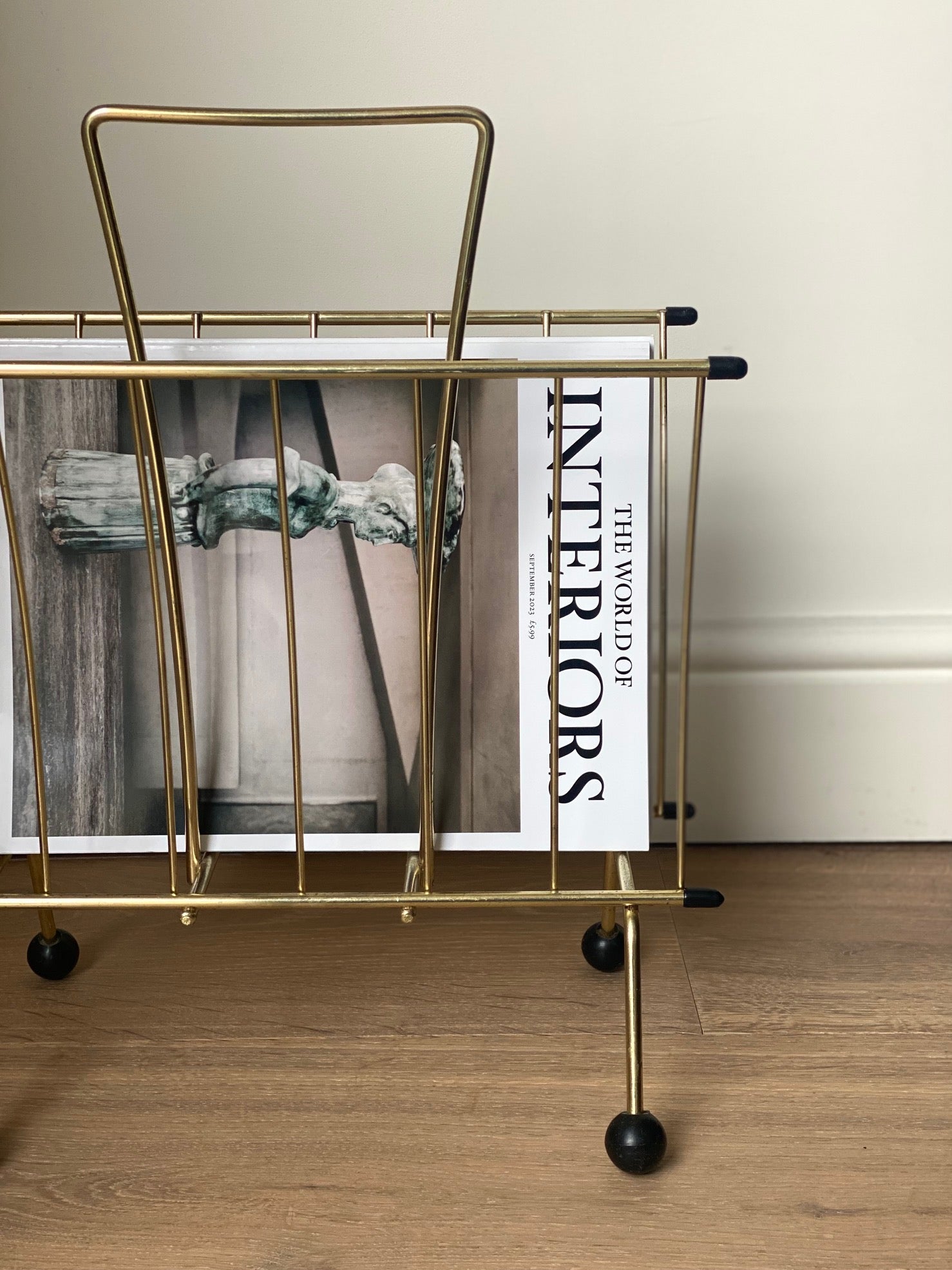 Brass magazine rack with ball feet