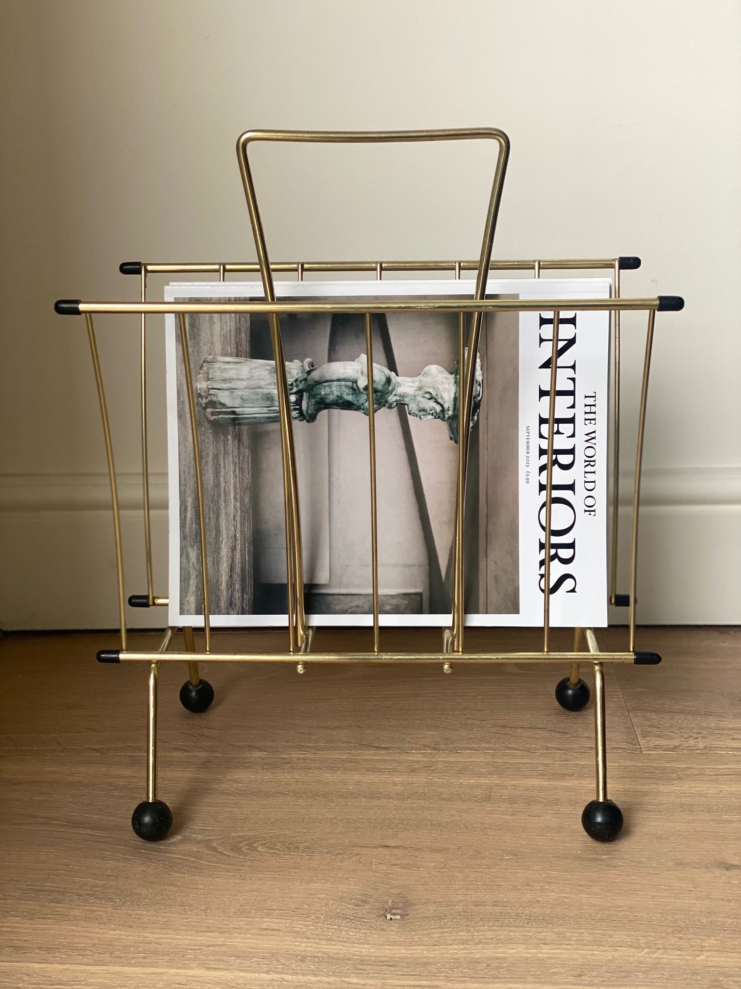 Brass magazine rack with ball feet