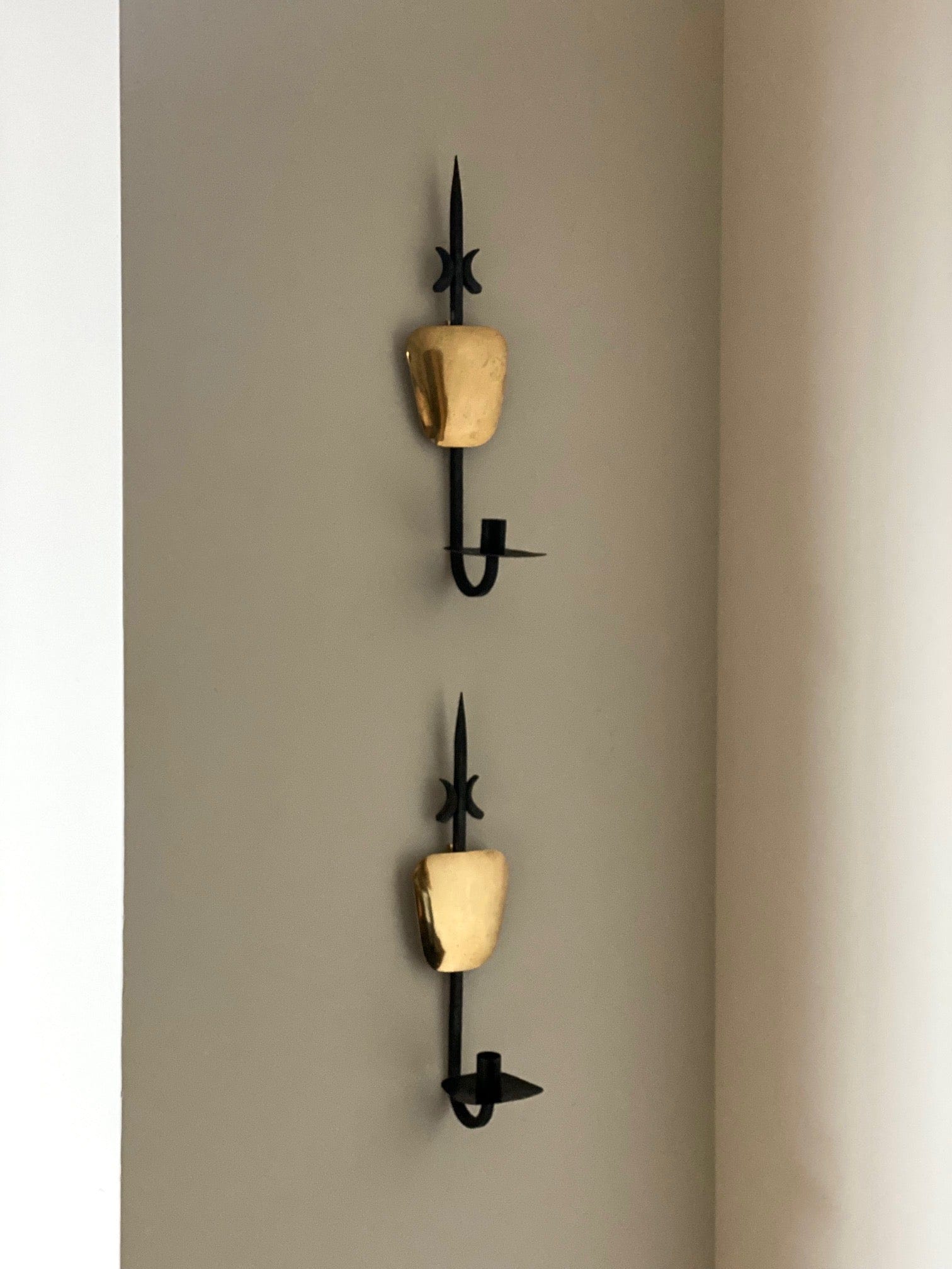 KEPT London A pair of iron and brass wall sconces