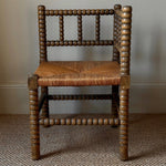 Load image into Gallery viewer, KEPT London Stock Corner bobbin turned chair with rush seat

