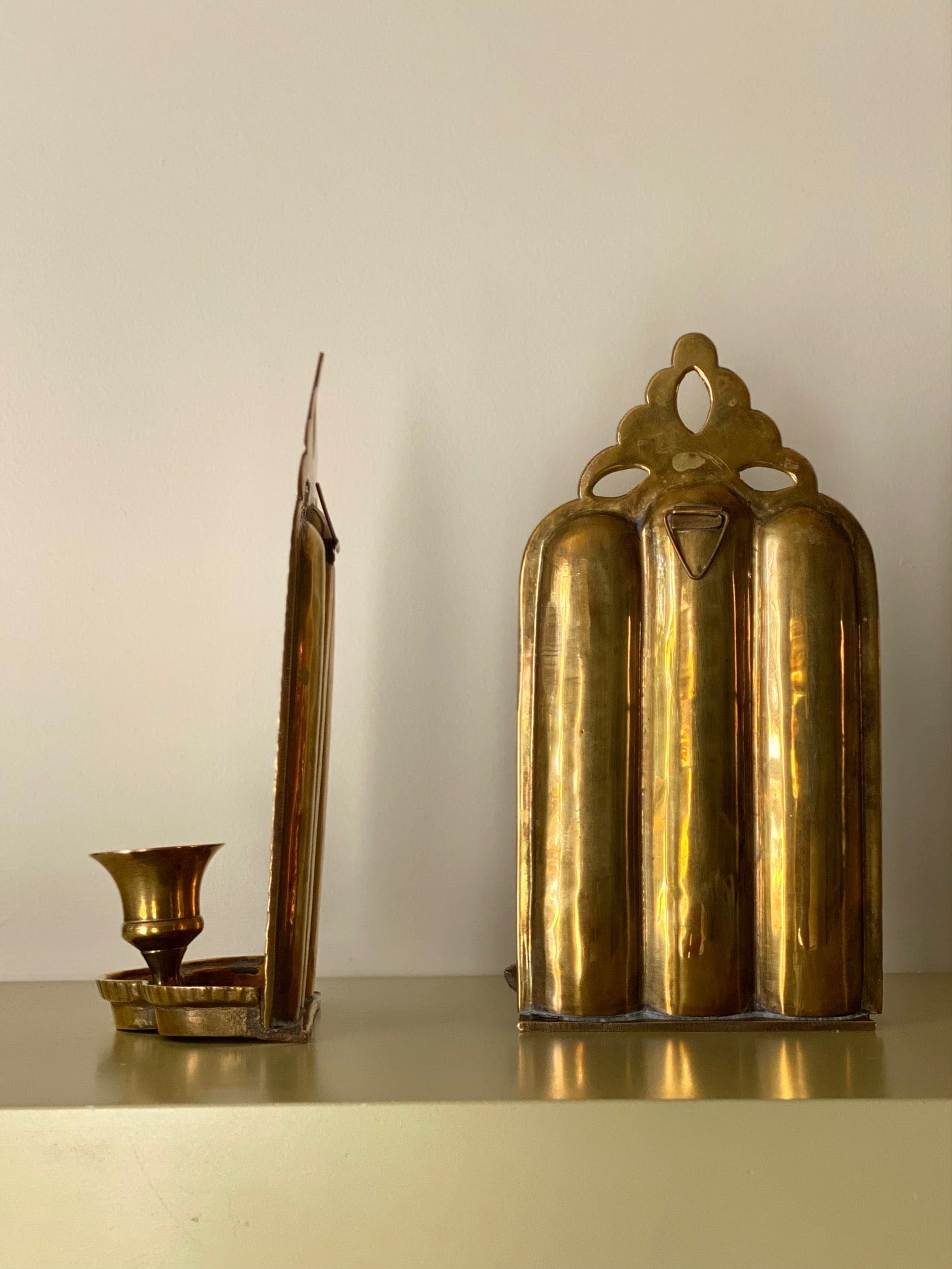 KEPT London Stock Pair of brass wall sconces, cut out detail