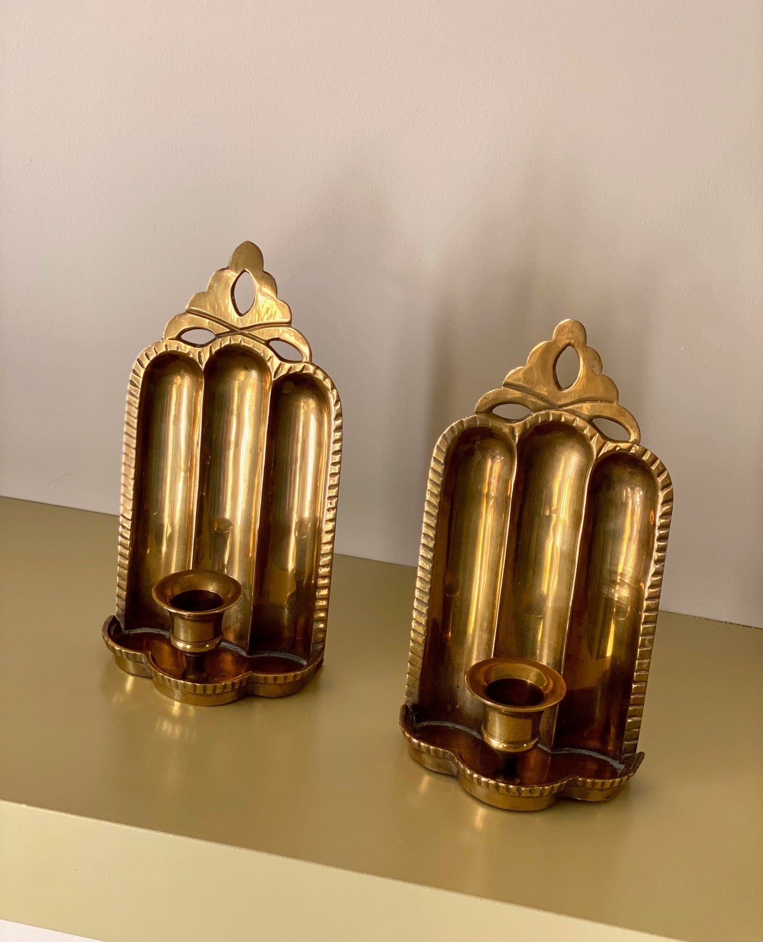 KEPT London Stock Pair of brass wall sconces, cut out detail