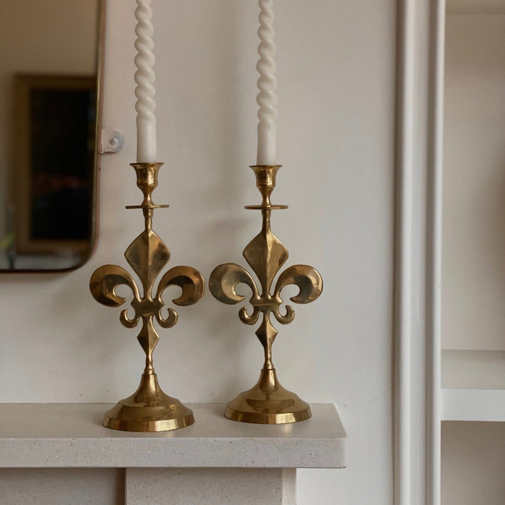 KEPT London Stock Pair of fleur de lis brass candlesticks