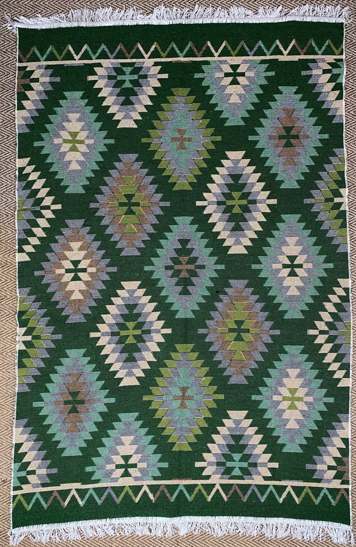 KEPT London Stock Pair of green and peach kilim style rugs