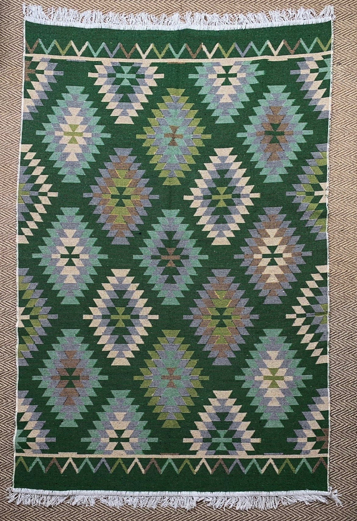KEPT London Stock Pair of green and peach kilim style rugs