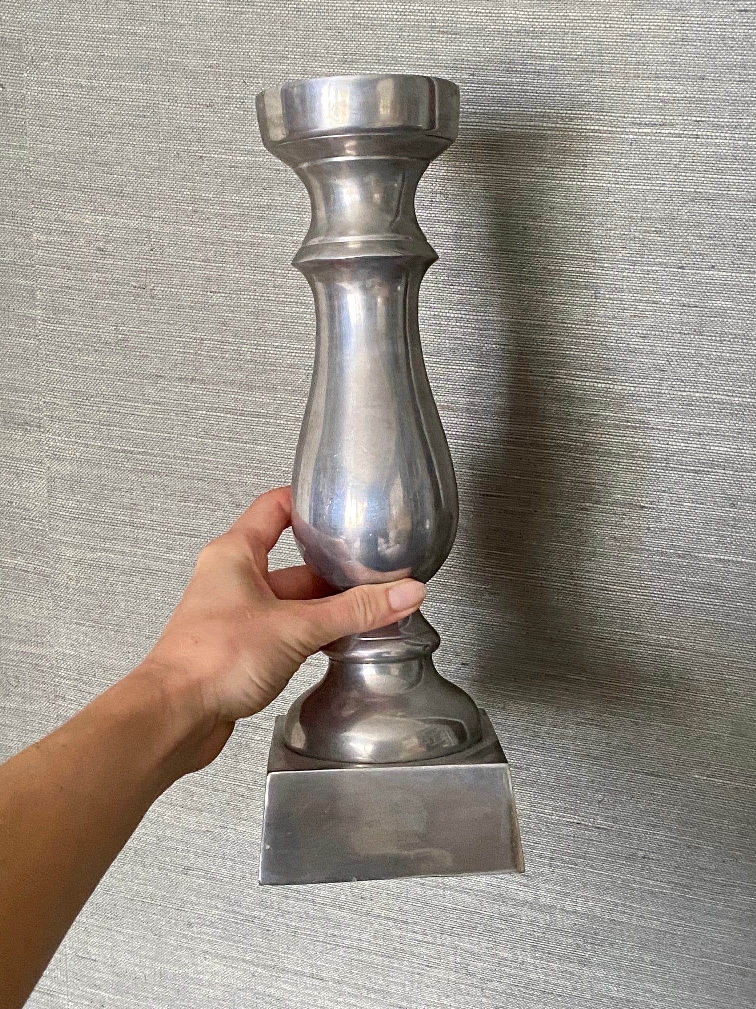 KEPT London Pair of silver metal candlesticks