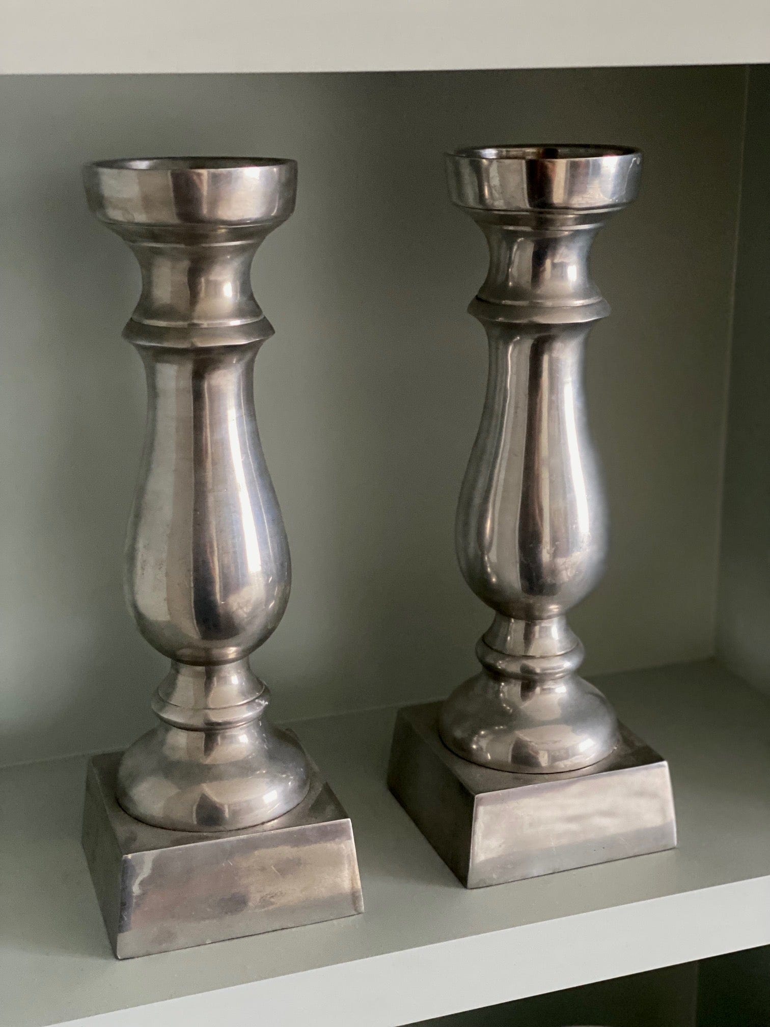 KEPT London Pair of silver metal candlesticks